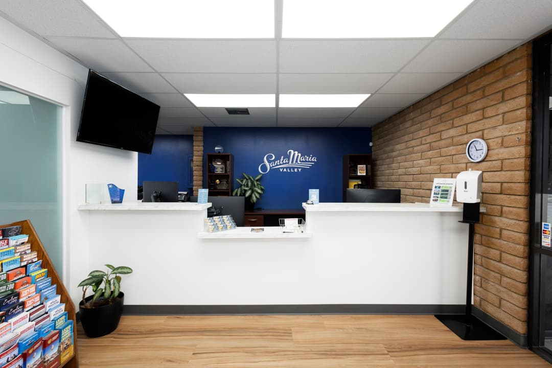 Modern reception area with blue and wood accents, greeting visitors at Santa Maria Valley.