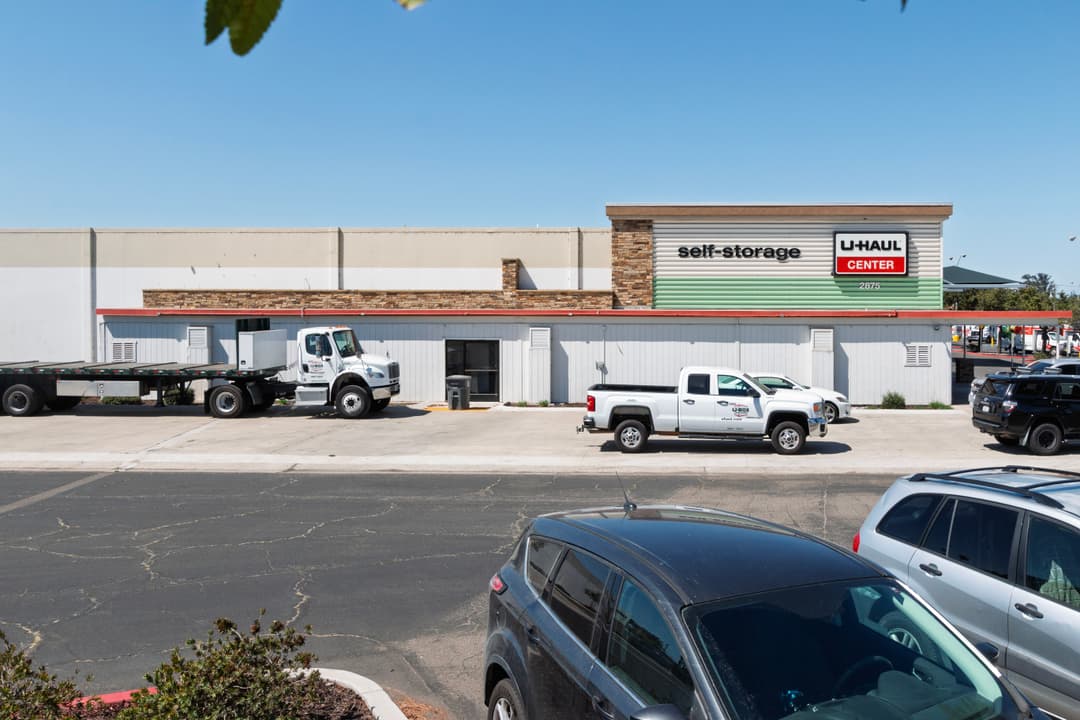 U-Haul self-storage facility with moving trucks parked in front on a clear day.