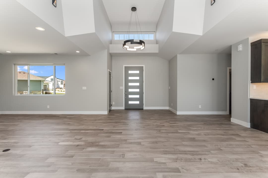 Bright, open-concept living room with modern decor and natural light from large windows.