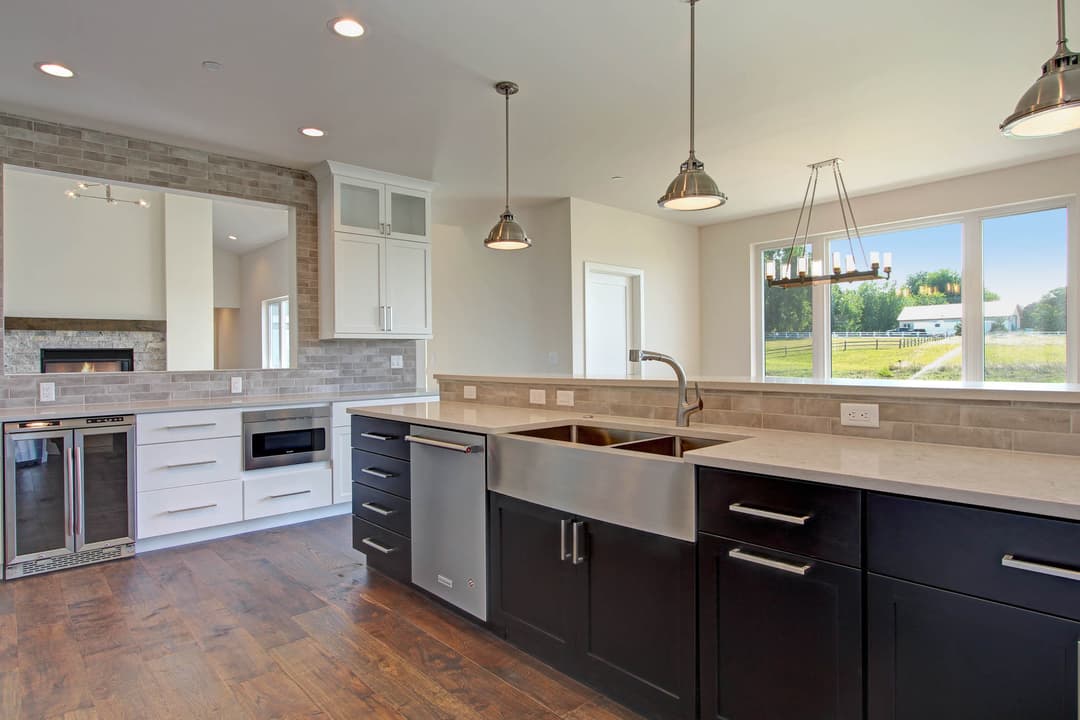 Modern kitchen with stainless steel appliances, farmhouse sink, and sleek cabinetry.