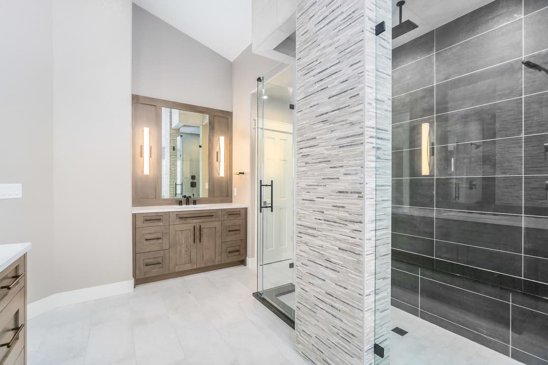 Spacious modern bathroom with walk-in shower and sleek cabinetry design.